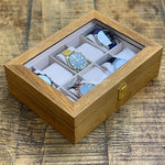 Une boîte à montres Boite a Montre Bois Luxueux à 10 fentes de Boites-lefiguet.com contenant quatre montres.