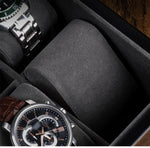 Une montre élégante avec un bracelet en argent à côté d'une Boites Lefiguet Boite 10 Montres Compartiments Larges contenant une autre montre luxueuse avec un bracelet en cuir.