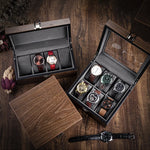Boîte à montres ouverte Boites Lefiguet présentant une collection de huit montres-bracelets élégantes, posées sur une table en bois rustique.