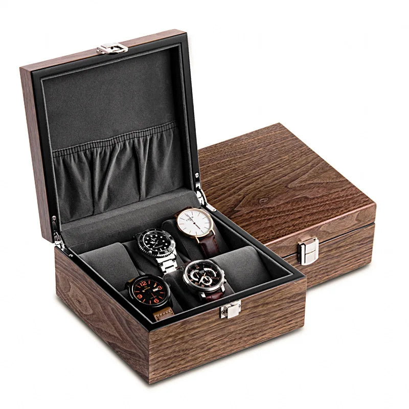 Une boîte à montres ouverte Boites Lefiguet présentant une collectionneurs montres de quatre montres de luxe aux designs variés, sur fond blanc.