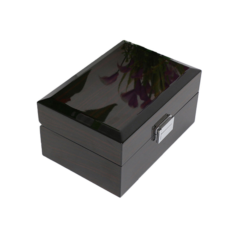 Une boîte à bijoux noire Boite 1 Montre avec une fleur de la marque Boites Lefiguet.
