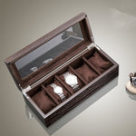 Une boîte à montres Boite a Montre Bois Marron 5 Slots de Boites-lefiguet.com avec trois montres à l'intérieur.