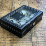 Une boîte de montre en cuir noir Boites Lefiguet contenant quatre montres Coffret montre et bijoux en cuir 8 fentes.