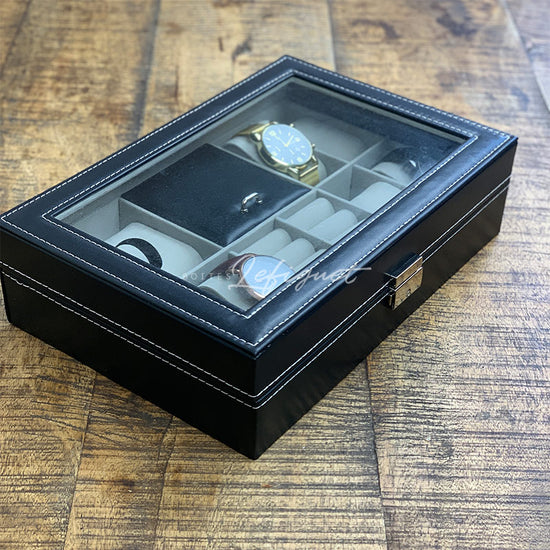 Une boîte de montre en cuir noir Boites Lefiguet contenant quatre montres Coffret montre et bijoux en cuir 8 fentes.